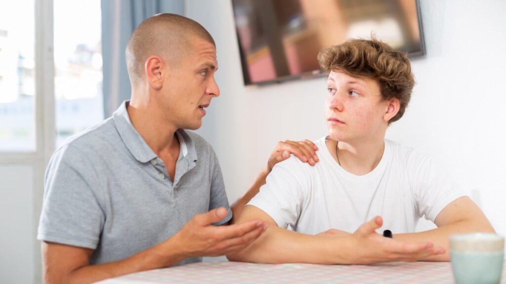 dad talking to son about considering adhd coaching