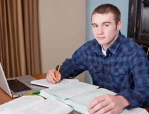 adhd coaching benefits represented by teen doing homework